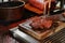 A man cooking beef steak on a grill.