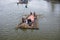 Man cooking on a boat in the river unique photo