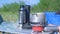 Man is cooking food using small gas burner in camping on nature, hands closeup.