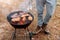 Man cooking, only hands, he is grilling meat or steak for a dish. Delicious grilled meat on grill. Barbecue weekend