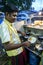 A man cooking hoppers in his restaurant near the Kataragama Temple in Sri Lanka.