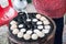 A man is cooking Kanom Krok