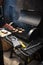 Man cooking marbled meat on barbecue for burgers