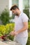 Man cooking meat on barbecue in the backyard of the house. Handsome man preparing barbecue. Barbecue chef master. Cook