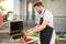 Man cooking meat on barbecue in the backyard of the house. Handsome man preparing barbecue. Barbecue chef master. Man in