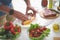 Man cooking meat while standing near kitchen table