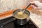 Man cooking pasta in skillet on electric touch glass panel