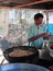 Man is cooking samosas outdoor in Kochi, India