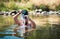 Man cooling down in a river on a summer day