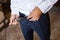 Man corrects belt, fees groom, man`s hands, dressing, man buttons pants, jeans.