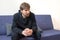 A man on the couch in the office of a psychologist. Young man at a doctors consultation. Psychology, psychotherapy