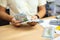 Man counting dollar banknotes on desk