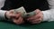 Man counting polish zloty on table. A man in a business shirt is counting Polish money. man hands count Polish banknotes