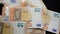 A man counts money - euro banknotes with a face value of 50 euros