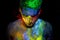 Man covered in glowing colorful powder