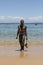 Man covered in oil on the beach at Porto da Barra in Salvador, Bahia, Brazil