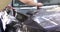 Man covering car with vinyl polyurethane tape closeup 4k movie