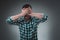 Man covering his eyes with hand, casual clothing. Studio shot.