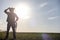 A man cowboy hat and a loso in the field. American farmer in a f