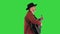 Man in a cowboy hat walking and playing guitar on a Green Screen, Chroma Key.