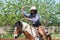 Man in a cowboy outfit with his horse