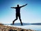 Man crazy jumping on beach. Sportsman flying on beach during the sunrise above horizon