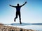 Man crazy jumping on beach. Sportsman flying on beach during the sunrise above horizon