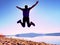 Man crazy jumping on beach. Sportsman flying on beach during the sunrise above horizon