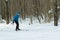 The man on the crosscountry skiing in winter forest.