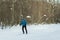 The man on the crosscountry skiing in winter forest.