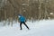 The man on the crosscountry skiing in winter forest.