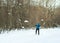 The man on the crosscountry skiing in winter forest.