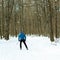 The man on the crosscountry skiing in winter forest.