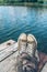 Man with crossed legs relaxing on riverbank pier