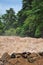 Man crosses the Khone Phapheng falls on the Mekong River in Laos on a rope during the Monsoon flooding