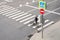 Man crosses the road at a pedestrian crossing and carries a bicycle next to him. View from above.