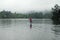 Man crossing lake using canoe