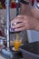 Man crushes juice from a fresh orange . Cooking freshly squeezed orange juice with a handheld machine