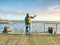 Man with a crutches on mole pier. Tourist with broken leg on crutches