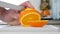 Man Cut with a Knife a Orange Fruit in Fresh Sweet and Flavored Slices