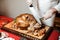 Man cuting baked chicken with a knife in a restaurant