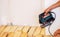 A man cuts a board with an electric saw. Repair of the floor in the house. Selective focus