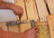 A man cuts a board with an electric saw. Repair of the floor in the house. Selective focus