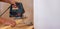 A man cuts a board with an electric saw. Repair of the floor in the house. Selective focus