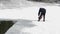 Man Cuts Ice With Chainsaw on the Frozen Lake