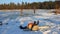 Man cuts ice with chainsaw on the frozen lake. Audio include. Saving swans and ducks on the frozen lake. Winter fishing
