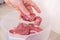 man cuts meat with knife on wooden board Preparation minced beef, pork for cutlets, meatballs, chops