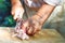 The man cuts meat of a ram for pilaf.