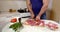 Man cuts meat to cook dish on board closeup slow motion