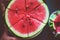 A man cuts a ripe red watermelon